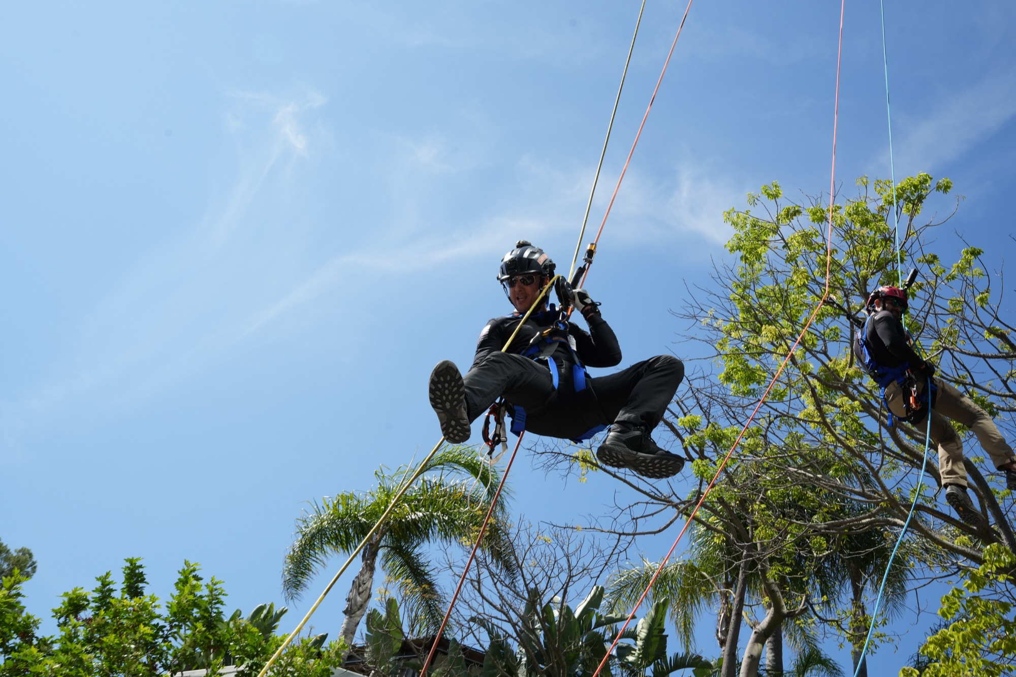 Rappellers mid-air at the Union Rescue Mission Over the Edge event