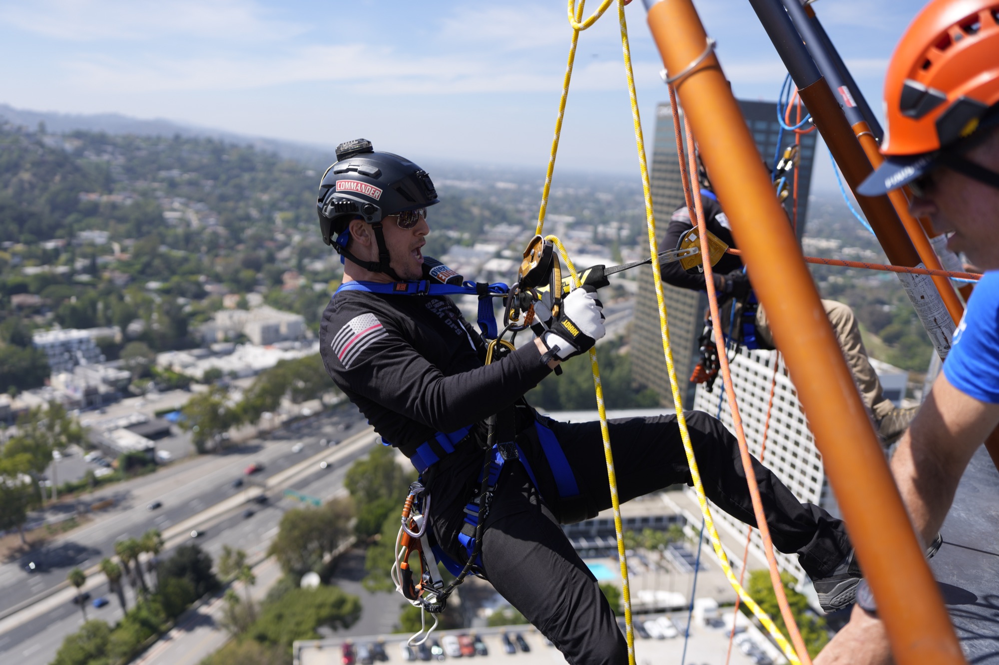 SAR OPS commander going over the edge on rope at the Union Rescue Mission event